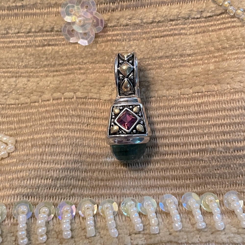 A beautiful, two toned pendant with Amethyst and a multi faceted green stone
